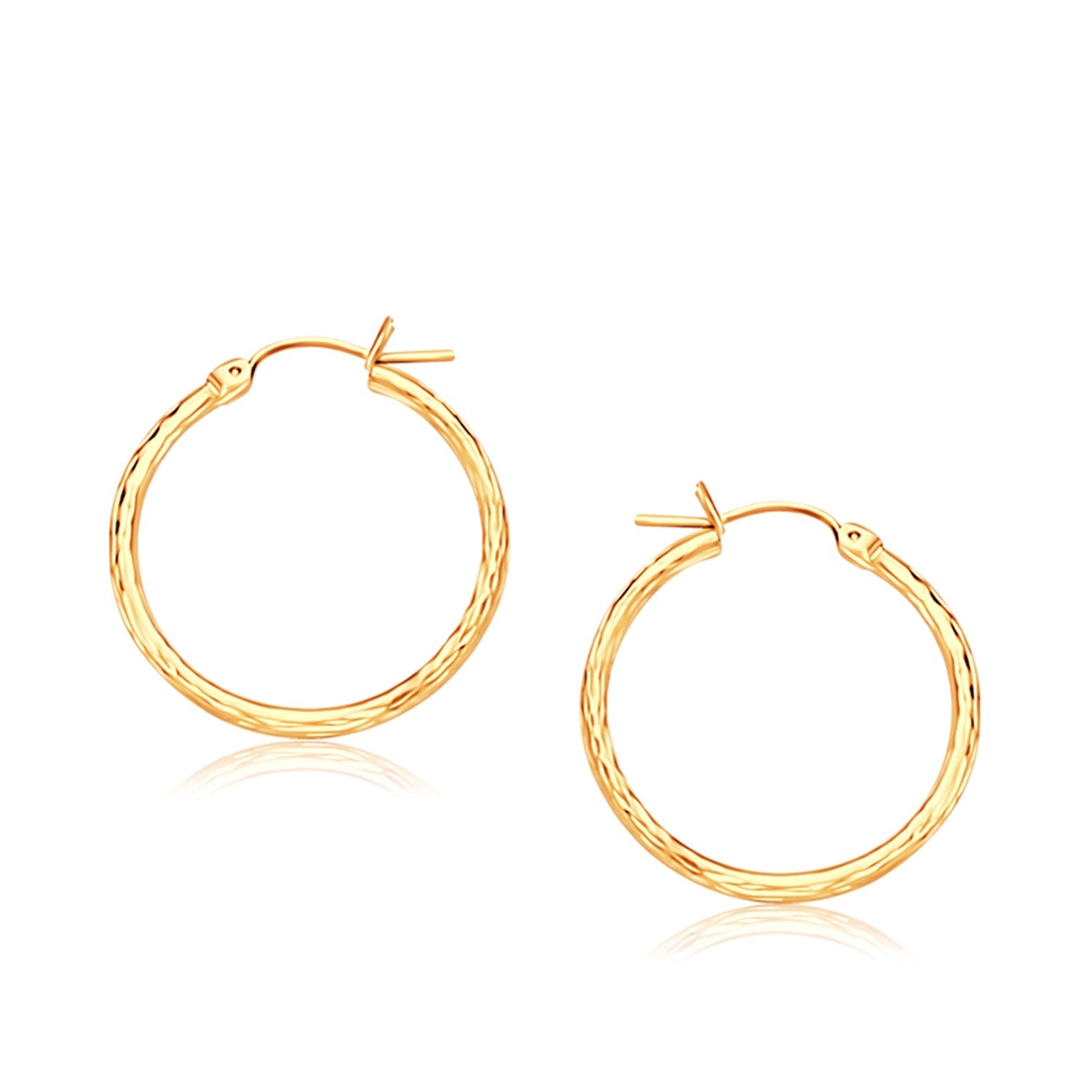 14k Yellow Gold Slender Hoop Earring with Diamond-Cut Finish (25mm Diameter) in a sleek high-contrast midnight luxury editori